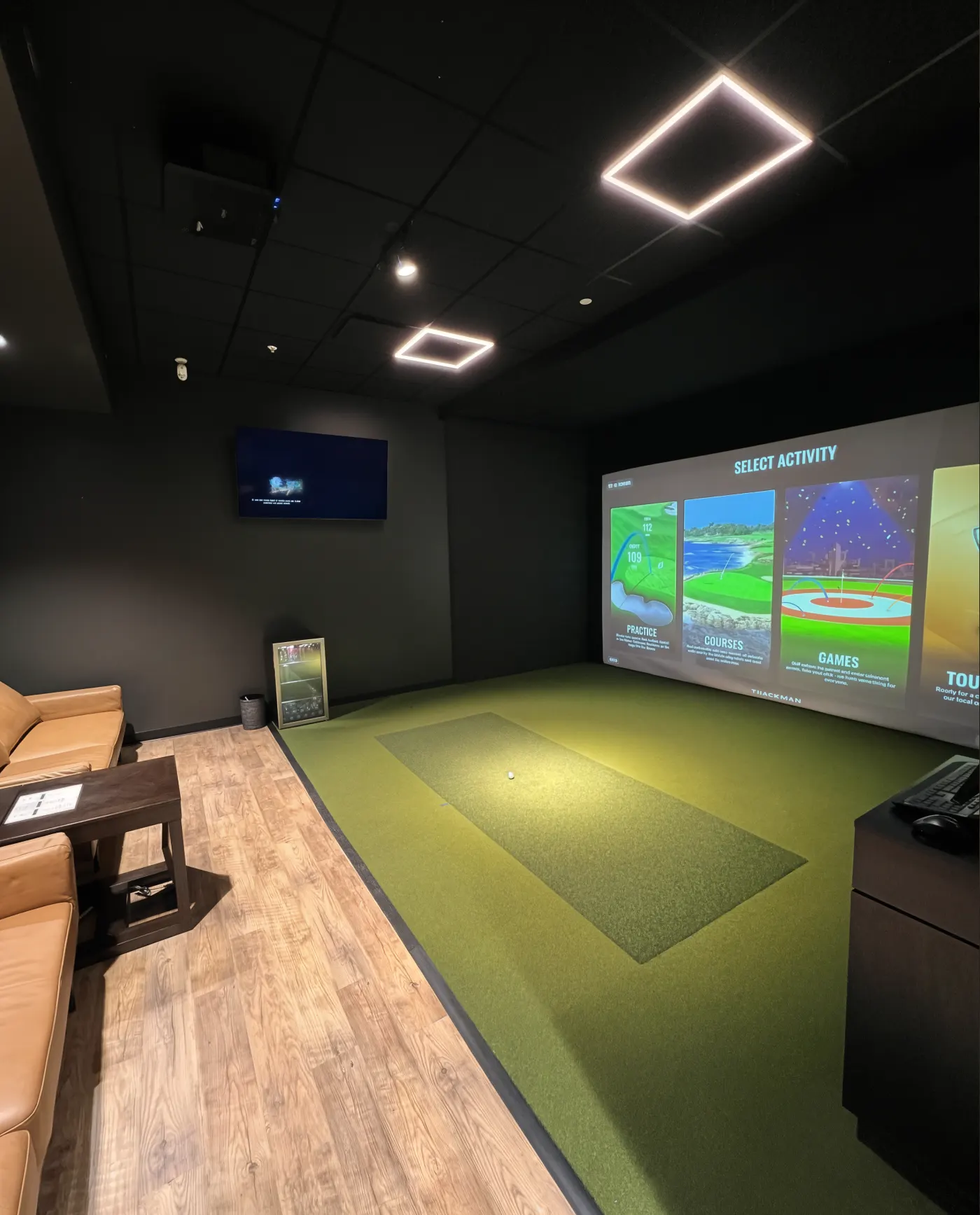 Simulator bay inside an indoor golf facility built by Butter's founder